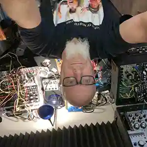 Photo de l'artiste Jim Coleman dans son studio la tête en bas